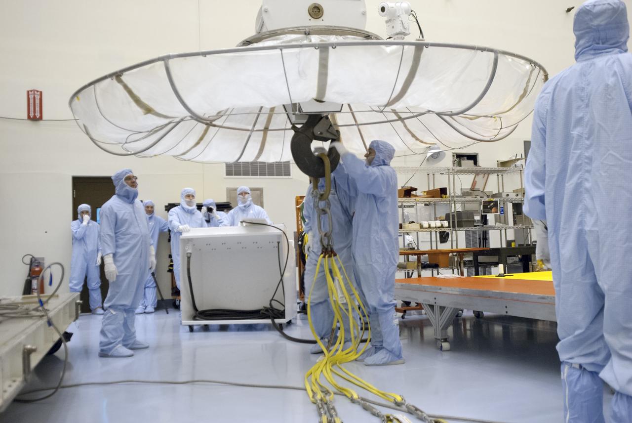 CAPE CANAVERAL, Fla. – Engineers prepare a crane to remove shipping material from around NASA’s Mars Atmosphere and Volatile Evolution MAVEN spacecraft inside the Payload Hazardous Servicing Facility on Aug. 3, 2013, at the agency’s Kennedy Space Center in Florida. MAVEN will be prepared inside the facility for its scheduled November launch to Mars. Positioned in an orbit above the Red Planet, MAVEN will study the upper atmosphere of Mars in unprecedented detail. Photo credit: NASA/Tim Jacobs