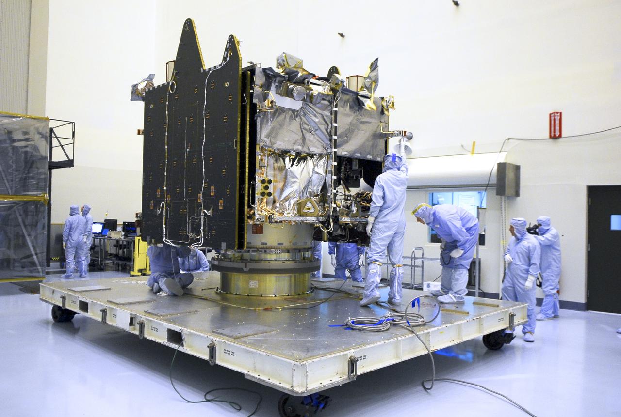 CAPE CANAVERAL, Fla. – Engineers examine NASA’s Mars Atmosphere and Volatile Evolution MAVEN spacecraft inside the Payload Hazardous Servicing Facility on Aug. 3, 2013, at the agency’s Kennedy Space Center in Florida. MAVEN will be prepared inside the facility for its scheduled November launch to Mars. Positioned in an orbit above the Red Planet, MAVEN will study the upper atmosphere of Mars in unprecedented detail. Photo credit: NASA/Tim Jacobs
