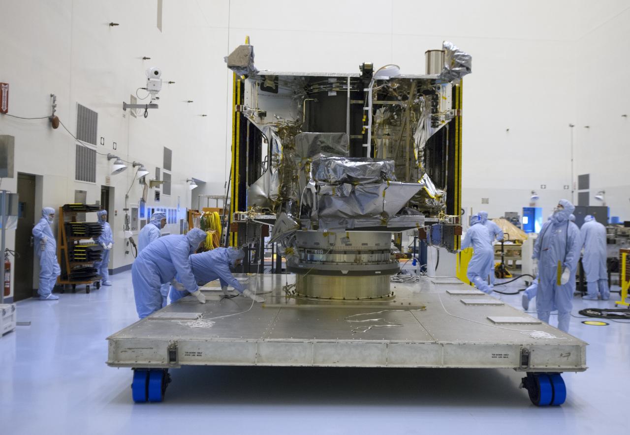 CAPE CANAVERAL, Fla. – Engineers examine NASA’s Mars Atmosphere and Volatile Evolution MAVEN spacecraft inside the Payload Hazardous Servicing Facility on Aug. 3, 2013, at the agency’s Kennedy Space Center in Florida. MAVEN will be prepared inside the facility for its scheduled November launch to Mars. Positioned in an orbit above the Red Planet, MAVEN will study the upper atmosphere of Mars in unprecedented detail. Photo credit: NASA/Tim Jacobs