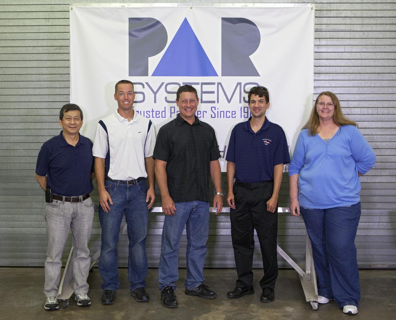 CAPE CANAVERAL, Fla. – In Hangar N at Cape Canaveral Air Force Station, PaR Systems, Inc. employees are performing nondestructive testing NDT work under a partnership agreement with NASA. From the left are: development engineer Wayne Cheng, operations engineer Jeff Elston, manager of NDT Services Tony Corak, development engineer Bence Bertha and operations engineer Lu Bell.      NASA's Kennedy Space Center in Florida recently established a partnership agreement with PaR Systems, Inc. of Shoreview, Minn., for operation of the Hangar N facility and its nondestructive testing and evaluation equipment. As the spaceport transitions from a historically government-only launch facility to a multi-user spaceport for both federal and commercial customers, partnerships between the space agency and other organizations will be a key element in that effort. Hangar N is located at Cape Canaveral Air Force Station adjacent to Kennedy and houses a unique inventory of test and evaluation equipment and the capability for current and future mission spaceflight support. Photo credit: NASA/ Dimitri Gerondidakis