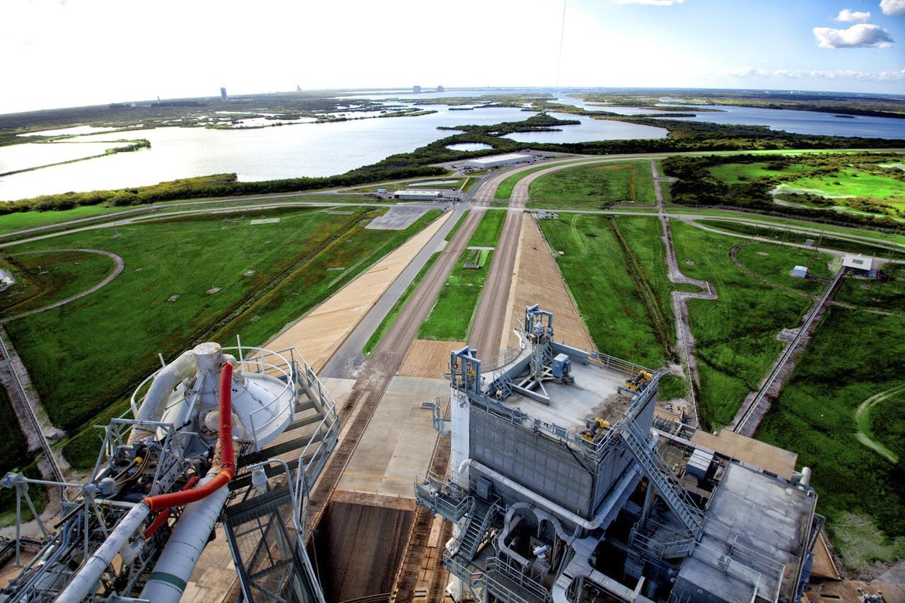 CAPE CANAVERAL, Fla. – As seen on Google Maps, the view from the top of the Fixed Service Structure at Launch Complex 39A at NASA's Kennedy Space Center. The FSS, as the structure is known, is 285 feet high and overlooks the Rotating Service Structure that was rolled into place when a space shuttle was at the pad. The path taken by NASA's massive crawler-transporters that carried the shuttle stack 3 miles from Vehicle Assembly Building are also visible leading up to the launch pad. In the distance are seen the launch pads and support structures at Cape Canaveral Air Force Station for the Atlas V, Delta IV and Falcon 9 rockets. Google precisely mapped the space center and some of its historical facilities for the company's map page. The work allows Internet users to see inside buildings at Kennedy as they were used during the space shuttle era. Photo credit: Google/Wendy Wang