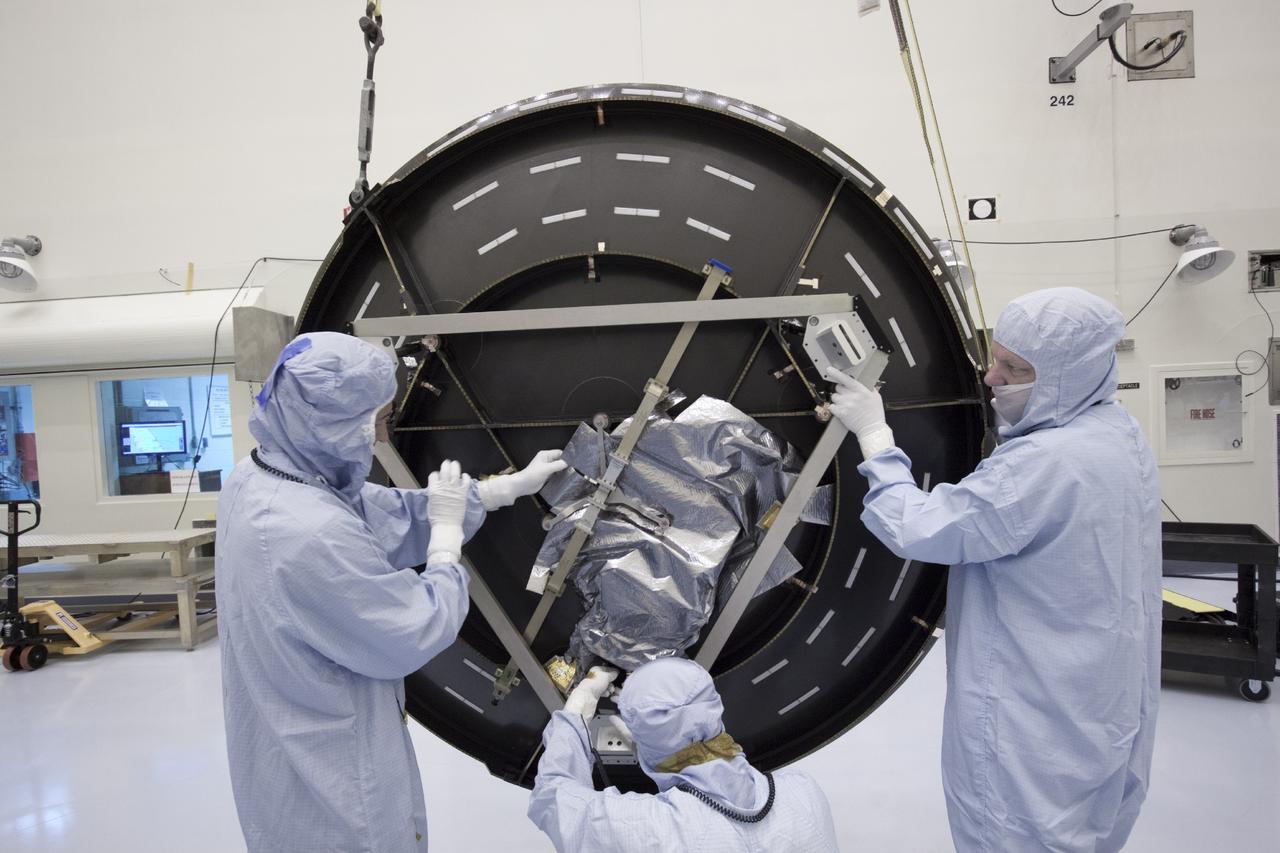 CAPE CANAVERAL, Fla. – Inside the Payload Hazardous Servicing Facility at NASA's Kennedy Space Center in Florida, technicians prepare to position the parabolic high gain antenna for installation on the Mars Atmosphere and Volatile Evolution, or MAVEN spacecraft.      The antenna will communicate vast amounts of data to Earth during the mission. MAVEN is being prepared inside the facility for its scheduled November launch aboard a United Launch Alliance Atlas V rocket to Mars. Positioned in an orbit above the Red Planet, MAVEN will study the upper atmosphere of Mars in unprecedented detail. Photo credit: NASA/Jim Grossmann