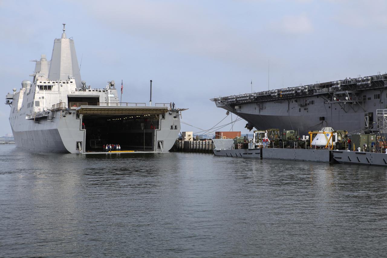 HAMPTON, Va. – At the Naval Station Norfolk near NASA’s Langley Research Center in Virginia, the Orion boilerplate test article and support equipment for a stationary recovery test are being transferred on a floating dock system to a U.S. Navy ship. NASA and the U.S. Navy are conducting tests to prepare for recovery of the Orion crew module and forward bay cover on its return from a deep space mission. The stationary recovery test will allow the teams to demonstrate and evaluate the recovery processes, procedures, hardware and personnel in a controlled environment before conducting a second recovery test next year in open waters. Orion is the exploration spacecraft designed to carry astronauts to destinations not yet explored by humans, including an asteroid and Mars. It will have emergency abort capability, sustain the crew during space travel and provide safe re-entry from deep space return velocities. The first unpiloted test flight of the Orion is scheduled to launch in 2014 atop a Delta IV rocket and in 2017 on a Space Launch System rocket. For more information, visit http://www.nasa.gov/orion. Photo credit: NASA/Dimitri Gerondidakis