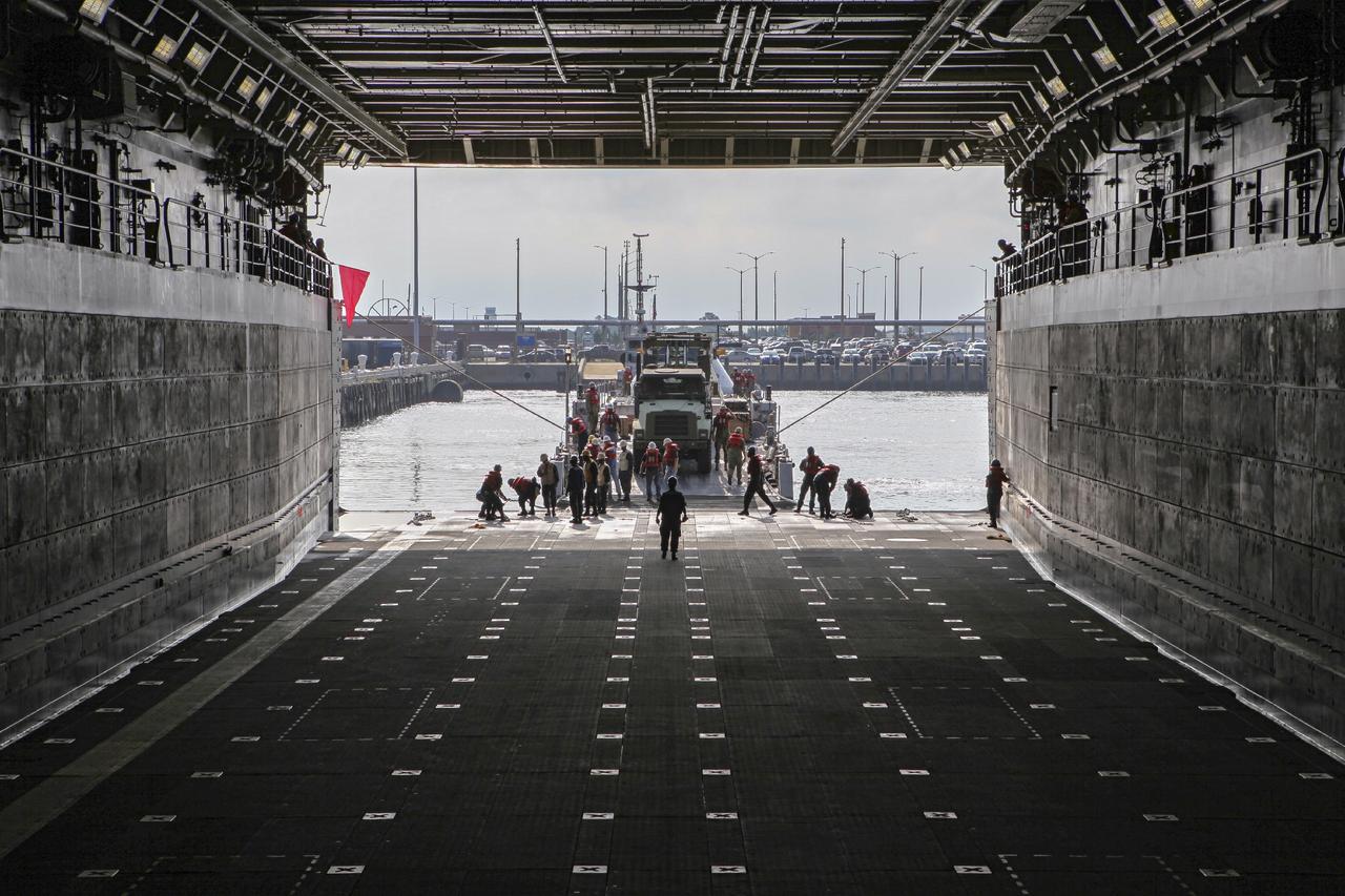 HAMPTON, Va. – At the Naval Station Norfolk near NASA’s Langley Research Center in Virginia, the Orion boilerplate test article and support equipment for a stationary recovery test are being transferred from a floating dock system to a U.S. Navy ship. NASA and the U.S. Navy are conducting tests to prepare for recovery of the Orion crew module and forward bay cover on its return from a deep space mission. The stationary recovery test will allow the teams to demonstrate and evaluate the recovery processes, procedures, hardware and personnel in a controlled environment before conducting a second recovery test next year in open waters. Orion is the exploration spacecraft designed to carry astronauts to destinations not yet explored by humans, including an asteroid and Mars. It will have emergency abort capability, sustain the crew during space travel and provide safe re-entry from deep space return velocities. The first unpiloted test flight of the Orion is scheduled to launch in 2014 atop a Delta IV rocket and in 2017 on a Space Launch System rocket. For more information, visit http://www.nasa.gov/orion. Photo credit: NASA/Dimitri Gerondidakis