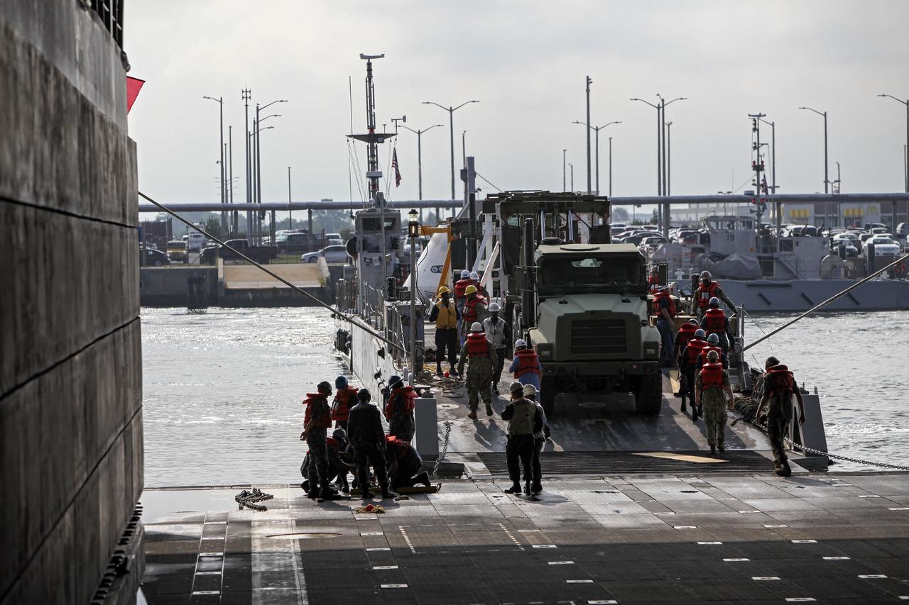 HAMPTON, Va. – At the Naval Station Norfolk near NASA’s Langley Research Center in Virginia, the Orion boilerplate test article and support equipment for a stationary recovery test are being transferred from a floating dock system to a U.S. Navy ship. NASA and the U.S. Navy are conducting tests to prepare for recovery of the Orion crew module and forward bay cover on its return from a deep space mission. The stationary recovery test will allow the teams to demonstrate and evaluate the recovery processes, procedures, hardware and personnel in a controlled environment before conducting a second recovery test next year in open waters. Orion is the exploration spacecraft designed to carry astronauts to destinations not yet explored by humans, including an asteroid and Mars. It will have emergency abort capability, sustain the crew during space travel and provide safe re-entry from deep space return velocities. The first unpiloted test flight of the Orion is scheduled to launch in 2014 atop a Delta IV rocket and in 2017 on a Space Launch System rocket. For more information, visit http://www.nasa.gov/orion. Photo credit: NASA/Dimitri Gerondidakis