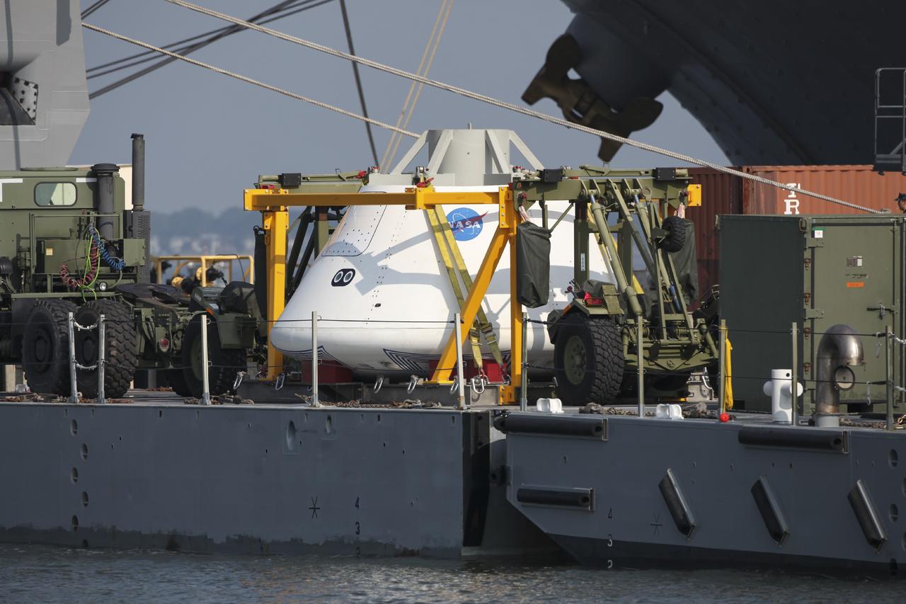 HAMPTON, Va. – At the Naval Station Norfolk near NASA’s Langley Research Center in Virginia, the Orion boilerplate test article and support equipment for a stationary recovery test are being transferred from a floating dock system to a U.S. Navy ship. NASA and the U.S. Navy are conducting tests to prepare for recovery of the Orion crew module and forward bay cover on its return from a deep space mission. The stationary recovery test will allow the teams to demonstrate and evaluate the recovery processes, procedures, hardware and personnel in a controlled environment before conducting a second recovery test next year in open waters. Orion is the exploration spacecraft designed to carry astronauts to destinations not yet explored by humans, including an asteroid and Mars. It will have emergency abort capability, sustain the crew during space travel and provide safe re-entry from deep space return velocities. The first unpiloted test flight of the Orion is scheduled to launch in 2014 atop a Delta IV rocket and in 2017 on a Space Launch System rocket. For more information, visit http://www.nasa.gov/orion. Photo credit: NASA/Dimitri Gerondidakis