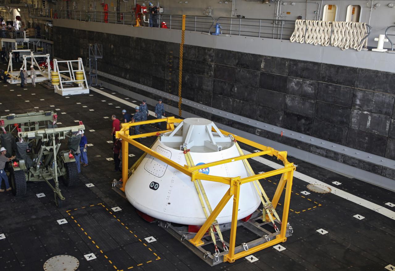 HAMPTON, Va. – At the Naval Station Norfolk near NASA’s Langley Research Center in Virginia, the Orion boilerplate test article and support equipment for a stationary recovery test have been secured on a U.S. Navy ship from a floating dock system. NASA and the U.S. Navy are conducting tests to prepare for recovery of the Orion crew module and forward bay cover on its return from a deep space mission. The stationary recovery test will allow the teams to demonstrate and evaluate the recovery processes, procedures, hardware and personnel in a controlled environment before conducting a second recovery test next year in open waters. Orion is the exploration spacecraft designed to carry astronauts to destinations not yet explored by humans, including an asteroid and Mars. It will have emergency abort capability, sustain the crew during space travel and provide safe re-entry from deep space return velocities. The first unpiloted test flight of the Orion is scheduled to launch in 2014 atop a Delta IV rocket and in 2017 on NASA’s Space Launch System rocket. For more information, visit http://www.nasa.gov/orion. Photo credit: NASA/Dimitri Gerondidakis