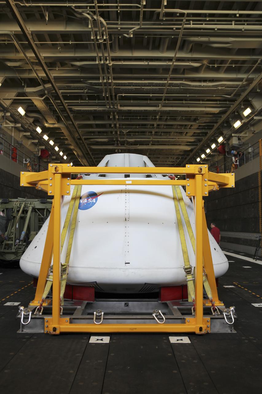 HAMPTON, Va. – At the Naval Station Norfolk near NASA’s Langley Research Center in Virginia, the Orion boilerplate test article was secured on a U.S. Navy ship after arriving by floating dock system for a stationary recovery test. NASA and the U.S. Navy are conducting tests to prepare for recovery of the Orion crew module and forward bay cover on its return from a deep space mission. The stationary recovery test will allow the teams to demonstrate and evaluate the recovery processes, procedures, hardware and personnel in a controlled environment before conducting a second recovery test next year in open waters. Orion is the exploration spacecraft designed to carry astronauts to destinations not yet explored by humans, including an asteroid and Mars. It will have emergency abort capability, sustain the crew during space travel and provide safe re-entry from deep space return velocities. The first unpiloted test flight of the Orion is scheduled to launch in 2014 atop a Delta IV rocket and in 2017 on NASA’s Space Launch System rocket. For more information, visit http://www.nasa.gov/orion. Photo credit: NASA/Dimitri Gerondidakis