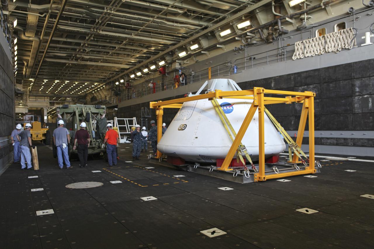 HAMPTON, Va. – At the Naval Station Norfolk near NASA’s Langley Research Center in Virginia, the Orion boilerplate test article and support equipment for a stationary recovery test have been secured on a U.S. Navy ship after arriving by floating dock system. NASA and the U.S. Navy are conducting tests to prepare for recovery of the Orion crew module and forward bay cover on its return from a deep space mission. The stationary recovery test will allow the teams to demonstrate and evaluate the recovery processes, procedures, hardware and personnel in a controlled environment before conducting a second recovery test next year in open waters. Orion is the exploration spacecraft designed to carry astronauts to destinations not yet explored by humans, including an asteroid and Mars. It will have emergency abort capability, sustain the crew during space travel and provide safe re-entry from deep space return velocities. The first unpiloted test flight of the Orion is scheduled to launch in 2014 atop a Delta IV rocket and in 2017 on NASA’s Space Launch System rocket. For more information, visit http://www.nasa.gov/orion. Photo credit: NASA/Dimitri Gerondidakis