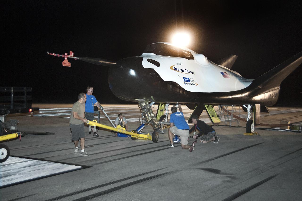 Edwards, Calif. – ED13-0266-013- Sierra Nevada Corporation, or SNC, team members prepare for 60 mph tow tests of the company's Dream Chaser flight vehicle on taxi and runways at NASA's Dryden Flight Research Center at Edwards Air Force Base in California. Ground testing at 10, 20, 40 and 60 miles per hour is helping the company validate the performance of the spacecraft's braking and landing systems prior to captive-carry and free-flight tests scheduled for later this year.                  SNC is continuing the development of its Dream Chaser spacecraft under the agency's Commercial Crew Development Round 2, or CCDev2, and Commercial Crew Integrated Capability, or CCiCap, phases, which are intended to lead to the availability of commercial human spaceflight services for government and commercial customers. To learn more about CCP and its industry partners, visit www.nasa.gov/commercialcrew. Image credit: NASA/Ken Ulbrich