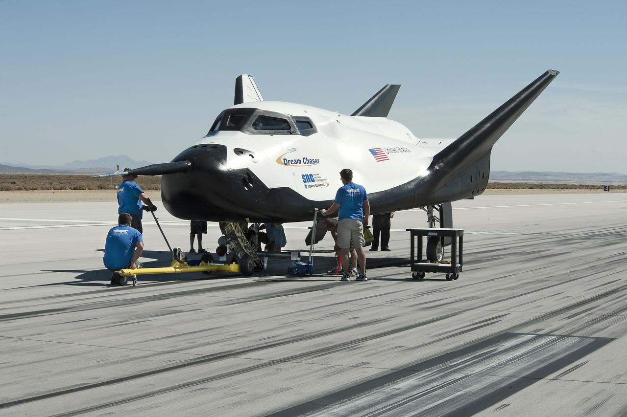 Edwards, Calif. – ED13-0266-054- Sierra Nevada Corporation, or SNC, team members check the company's Dream Chaser flight vehicle systems following a 60 mph tow test on taxi and runways at NASA's Dryden Flight Research Center at Edwards Air Force Base in California. Ground testing at 10, 20, 40 and 60 miles per hour is helping the company validate the performance of the spacecraft's braking and landing systems prior to captive-carry and free-flight tests scheduled for later this year.              SNC is continuing the development of its Dream Chaser spacecraft under the agency's Commercial Crew Development Round 2, or CCDev2, and Commercial Crew Integrated Capability, or CCiCap, phases, which are intended to lead to the availability of commercial human spaceflight services for government and commercial customers. To learn more about CCP and its industry partners, visit www.nasa.gov/commercialcrew. Image credit: NASA/Ken Ulbrich