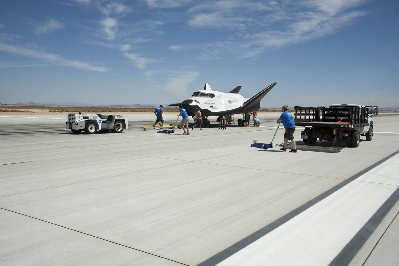 Edwards, Calif. – ED13-0266-069- Sierra Nevada Corporation, or SNC, team members check the company's Dream Chaser flight vehicle systems following a 60 mph tow test on taxi and runways at NASA's Dryden Flight Research Center at Edwards Air Force Base in California. Ground testing at 10, 20, 40 and 60 miles per hour is helping the company validate the performance of the spacecraft's braking and landing systems prior to captive-carry and free-flight tests scheduled for later this year.          SNC is continuing the development of its Dream Chaser spacecraft under the agency's Commercial Crew Development Round 2, or CCDev2, and Commercial Crew Integrated Capability, or CCiCap, phases, which are intended to lead to the availability of commercial human spaceflight services for government and commercial customers. To learn more about CCP and its industry partners, visit www.nasa.gov/commercialcrew. Image credit: NASA/Ken Ulbrich