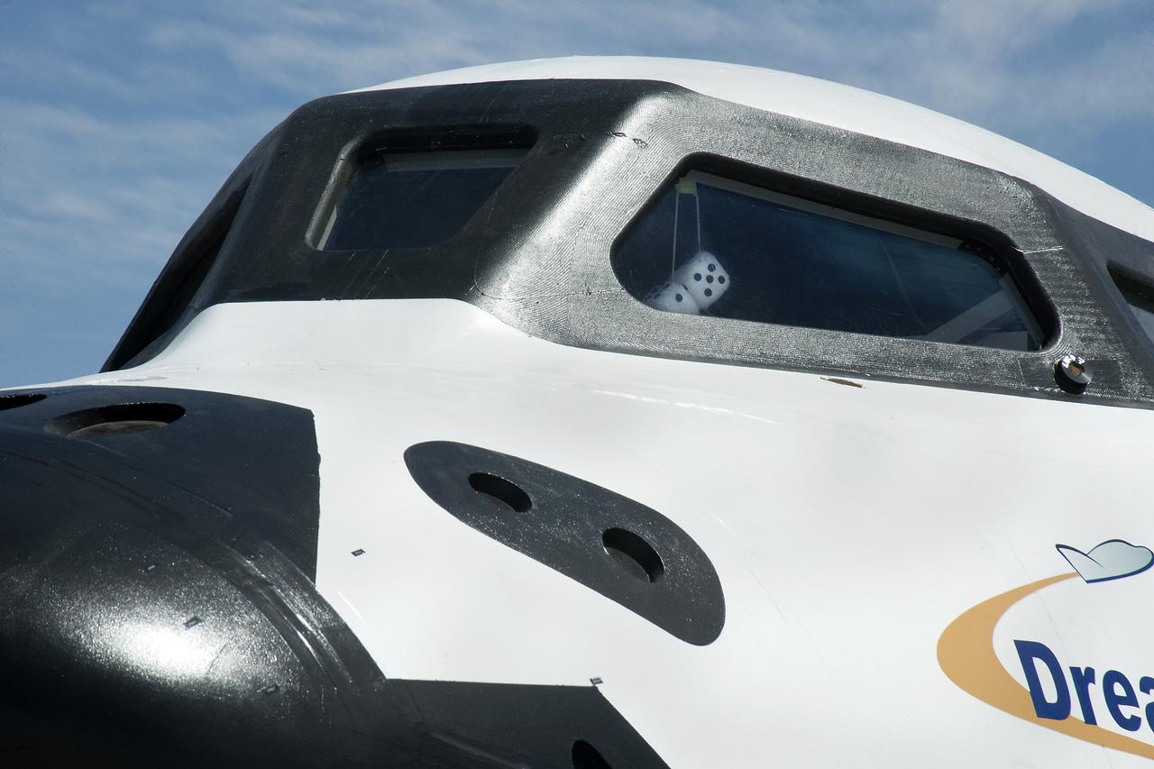 Edwards, Calif. – ED13-0266-074- Sierra Nevada Corporation's, or SNC's, Dream Chaser flight vehicle sports a pair of fuzzy dice during 60 mph tow tests at NASA's Dryden Flight Research Center in California. Ground testing at 10, 20, 40 and 60 miles per hour is helping the company validate the performance of the spacecraft's braking and landing systems prior to captive-carry and free-flight tests scheduled for later this year.      SNC is continuing the development of its Dream Chaser spacecraft under the agency's Commercial Crew Development Round 2, or CCDev2, and Commercial Crew Integrated Capability, or CCiCap, phases, which are intended to lead to the availability of commercial human spaceflight services for government and commercial customers. To learn more about CCP and its industry partners, visit www.nasa.gov/commercialcrew. Image credit: NASA/Ken Ulbrich
