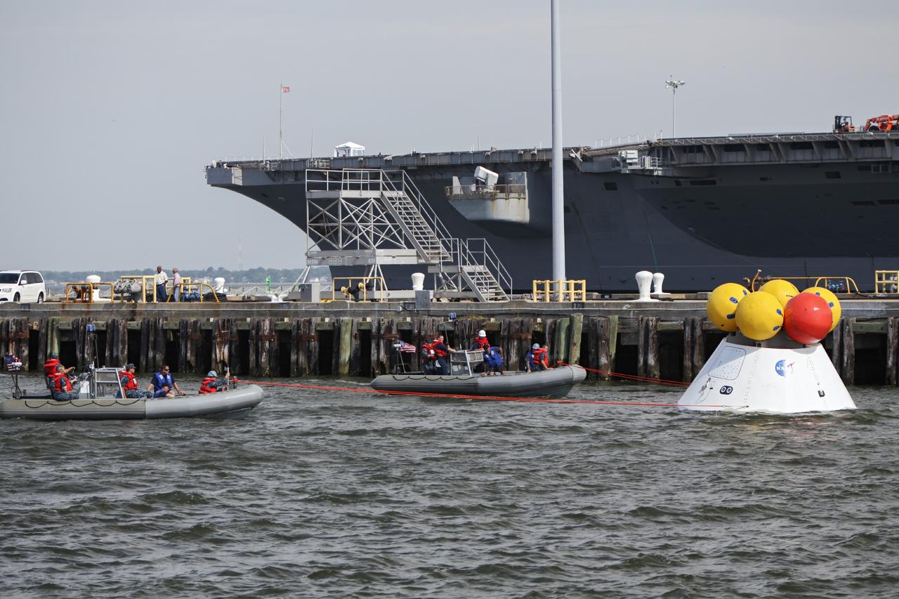 HAMPTON, Va. – At the Naval Station Norfolk near NASA’s Langley Research Center in Virginia, NASA and U.S. Navy personnel have attached tether lines to the Orion boilerplate test article for a stationary recovery test. NASA and the U.S. Navy are conducting tests to prepare for recovery of the Orion crew module and forward bay cover on its return from a deep space mission. The stationary recovery test will allow the teams to demonstrate and evaluate the recovery processes, procedures, hardware and personnel in a controlled environment before conducting a second recovery test next year in open waters. Orion is the exploration spacecraft designed to carry astronauts to destinations not yet explored by humans, including an asteroid and Mars. It will have emergency abort capability, sustain the crew during space travel and provide safe re-entry from deep space return velocities. The first unpiloted test flight of the Orion is scheduled to launch in 2014 atop a Delta IV rocket and in 2017 on NASA’s Space Launch System rocket. For more information, visit http://www.nasa.gov/orion. Photo credit: NASA/Dimitri Gerondidakis