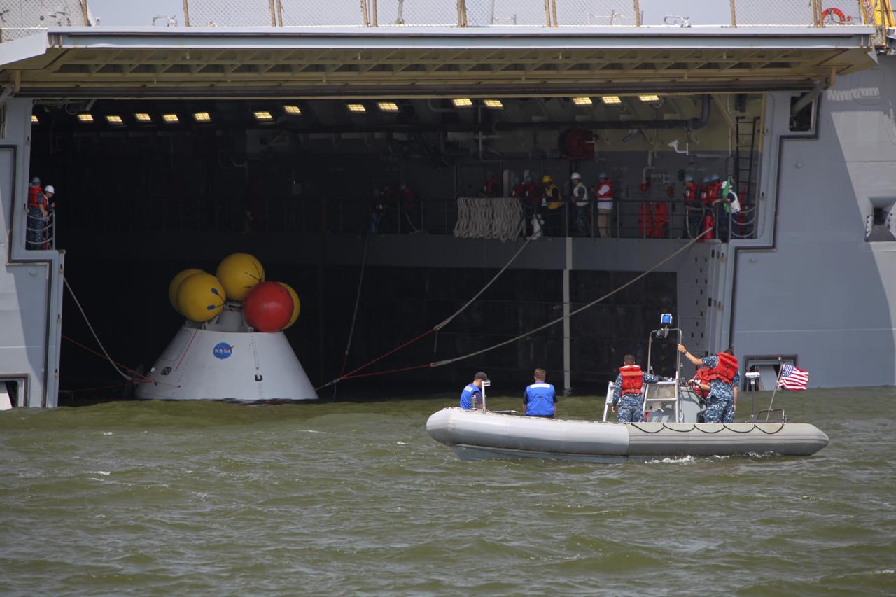 HAMPTON, Va. – At the Naval Station Norfolk near NASA’s Langley Research Center in Virginia, the Orion boilerplate test article has been returned to a U.S. Navy ship following a stationary recovery test in the water. NASA and the U.S. Navy are conducting tests to prepare for recovery of the Orion crew module and forward bay cover on its return from a deep space mission. The stationary recovery test will allow the teams to demonstrate and evaluate the recovery processes, procedures, hardware and personnel in a controlled environment before conducting a second recovery test next year in open waters. Orion is the exploration spacecraft designed to carry astronauts to destinations not yet explored by humans, including an asteroid and Mars. It will have emergency abort capability, sustain the crew during space travel and provide safe re-entry from deep space return velocities. The first unpiloted test flight of the Orion is scheduled to launch in 2014 atop a Delta IV rocket and in 2017 on NASA’s Space Launch System rocket. For more information, visit http://www.nasa.gov/orion. Photo credit: NASA/Dimitri Gerondidakis