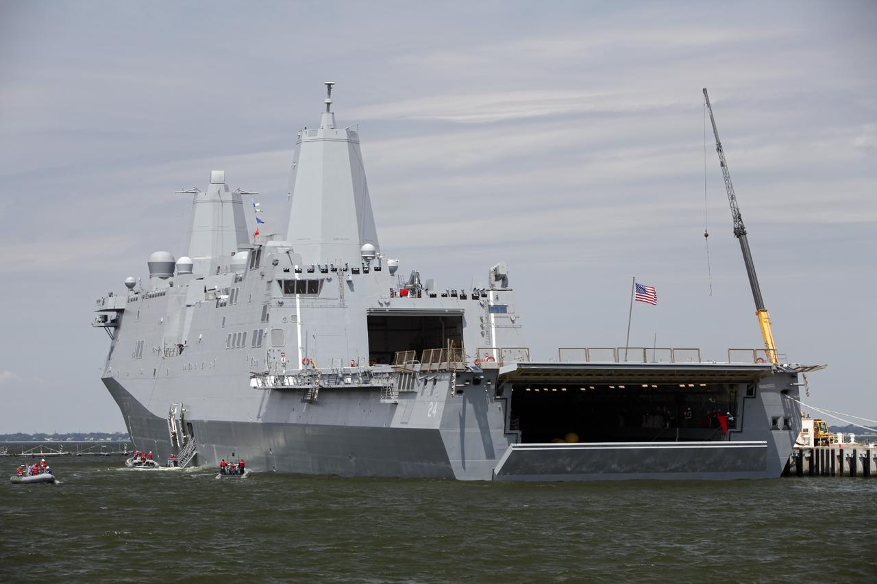 HAMPTON, Va. – At the Naval Station Norfolk near NASA’s Langley Research Center in Virginia, the Orion boilerplate test article has been returned to a U.S. Navy ship following a stationary recovery test in the water. NASA and the U.S. Navy are conducting tests to prepare for recovery of the Orion crew module and forward bay cover on its return from a deep space mission. The stationary recovery test will allow the teams to demonstrate and evaluate the recovery processes, procedures, hardware and personnel in a controlled environment before conducting a second recovery test next year in open waters. Orion is the exploration spacecraft designed to carry astronauts to destinations not yet explored by humans, including an asteroid and Mars. It will have emergency abort capability, sustain the crew during space travel and provide safe re-entry from deep space return velocities. The first unpiloted test flight of the Orion is scheduled to launch in 2014 atop a Delta IV rocket and in 2017 on NASA’s Space Launch System rocket. For more information, visit http://www.nasa.gov/orion. Photo credit: NASA/Dimitri Gerondidakis