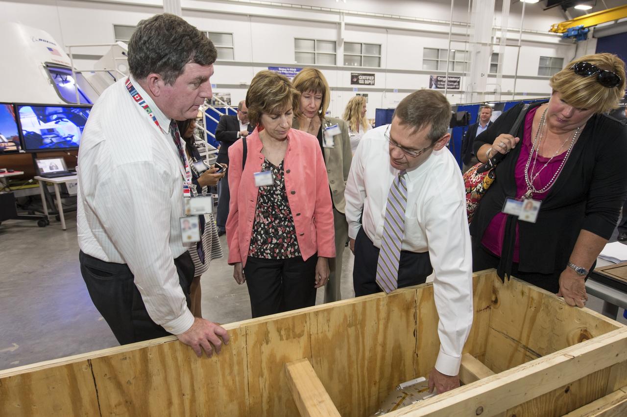 HOUSTON -- JSC-2013-E076043 -- John Elbon, The Boeing Company's vice president of Space Exploration, second right, shows off a wind tunnel model of the CST-100 spacecraft to Johnson Space Center management at the company's Houston Product Support Center. From left, are Kirk Shireman, Johnson's deputy director, Ellen Ochoa, Johnson's director, Kathy Lueders, deputy director of NASA's Commercial Crew Program, Elbon, and Melanie Saunders, Johnson's associate director.          Boeing's CST-100 is designed to transport a mix of crew and cargo to low-Earth-orbit destinations. Boeing is one of three aerospace industry partners working with NASA's Commercial Crew Program, or CCP, during the Commercial Crew Integrated Capability, or CCiCap, initiative, which is intended to make commercial human spaceflight services available for government and commercial customers. To learn more about CCP, visit www.nasa.gov/commercialcrew. Photo credit: NASA/James Blair