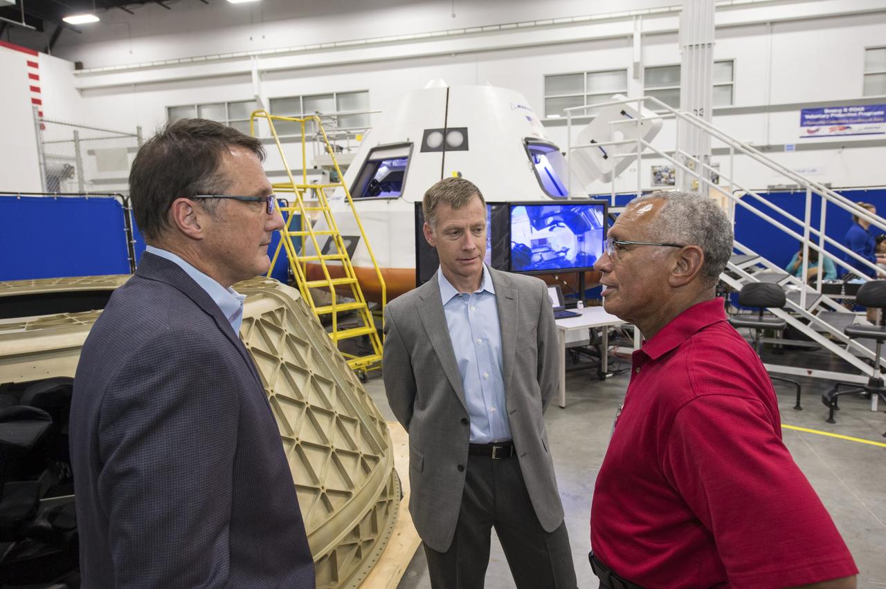 HOUSTON -- JSC-2013-E076048 -- NASA Administrator Charlie Bolden, right, talks to The Boeing Company's Vice President and Program Manager of Commercial Programs John Mulholland, left, and Director of Crew and Mission Operations Chris Ferguson at the company's Houston Product Support Center near Johnson Space Center. Boeing showcased its work on a fully outfitted test version of the CST-100 spacecraft to Bolden and Johnson management.        Boeing's CST-100 is designed to transport a mix of crew and cargo to low-Earth-orbit destinations. Boeing is one of three aerospace industry partners working with NASA's Commercial Crew Program, or CCP, during the Commercial Crew Integrated Capability, or CCiCap, initiative, which is intended to make commercial human spaceflight services available for government and commercial customers. To learn more about CCP, visit www.nasa.gov/commercialcrew. Photo credit: NASA/James Blair