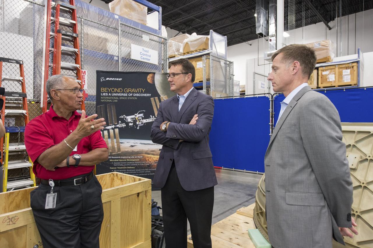 HOUSTON -- JSC-2013-E076054 -- NASA Administrator Charlie Bolden, left, talks to The Boeing Company's Vice President and Program Manager of Commercial Programs John Mulholland, center, and Director of Crew and Mission Operations Chris Ferguson at the company's Houston Product Support Center near Johnson Space Center. Boeing showcased its work on a fully outfitted test version of the CST-100 spacecraft to Bolden and Johnson management.        Boeing's CST-100 is designed to transport a mix of crew and cargo to low-Earth-orbit destinations. Boeing is one of three aerospace industry partners working with NASA's Commercial Crew Program, or CCP, during the Commercial Crew Integrated Capability, or CCiCap, initiative, which is intended to make commercial human spaceflight services available for government and commercial customers. To learn more about CCP, visit www.nasa.gov/commercialcrew. Photo credit: NASA/James Blair