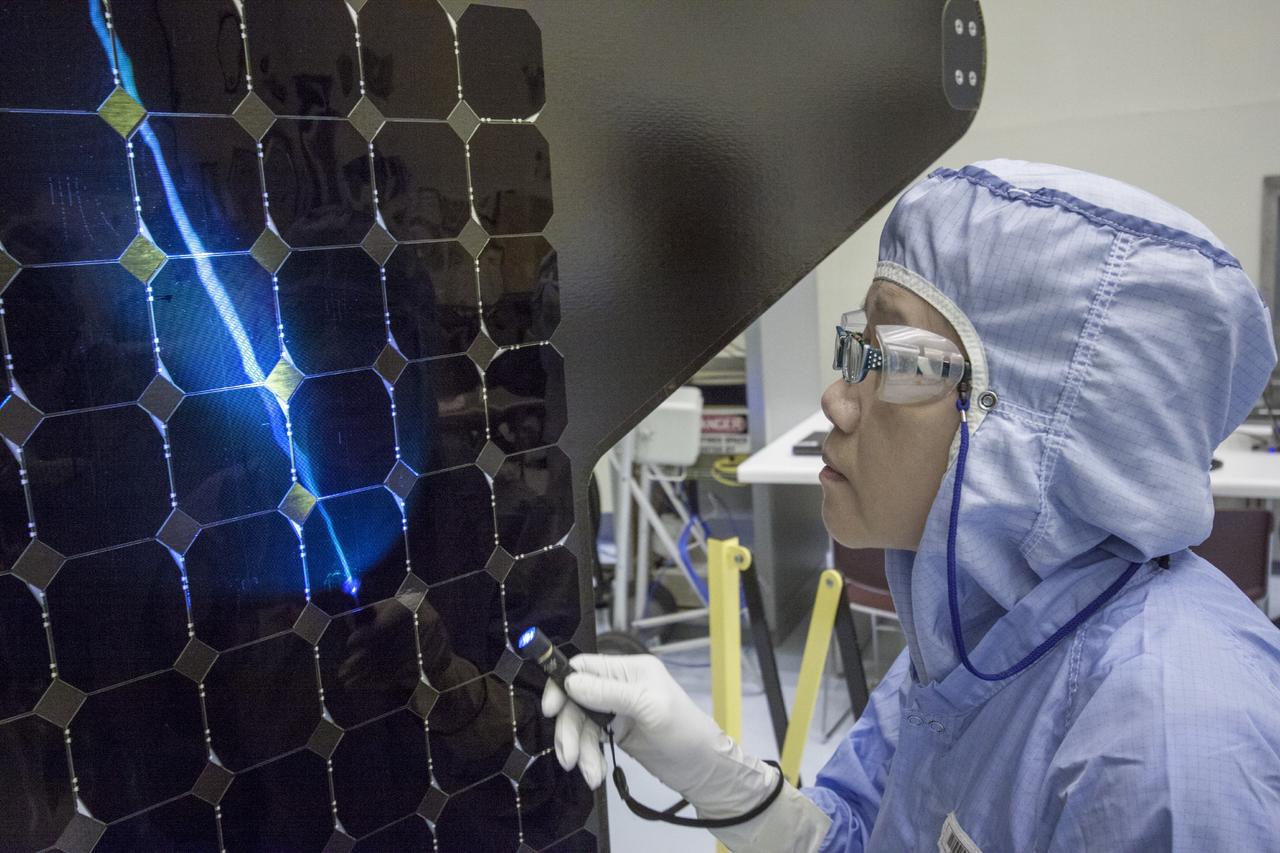 CAPE CANAVERAL, Fla. – Inside the Payload Hazardous Servicing Facility at NASA's Kennedy Space Center in Florida, a technician inspects one of the solar arrays for the Mars Atmosphere and Volatile Evolution, or MAVEN spacecraft. MAVEN is being prepared inside the facility for its scheduled November launch aboard a United Launch Alliance Atlas V rocket to Mars. Positioned in an orbit above the Red Planet, MAVEN will study the upper atmosphere of Mars in unprecedented detail. Photo credit: NASA/Jim Grossmann