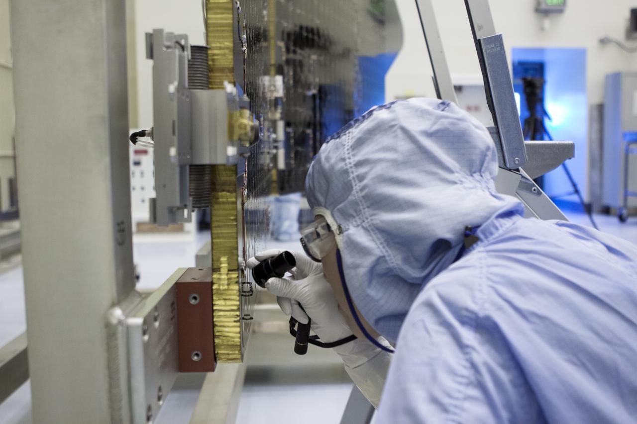 CAPE CANAVERAL, Fla. – Inside the Payload Hazardous Servicing Facility at NASA's Kennedy Space Center in Florida, a technician inspects one of the solar arrays for the Mars Atmosphere and Volatile Evolution, or MAVEN spacecraft. MAVEN is being prepared inside the facility for its scheduled November launch aboard a United Launch Alliance Atlas V rocket to Mars. Positioned in an orbit above the Red Planet, MAVEN will study the upper atmosphere of Mars in unprecedented detail. Photo credit: NASA/Jim Grossmann