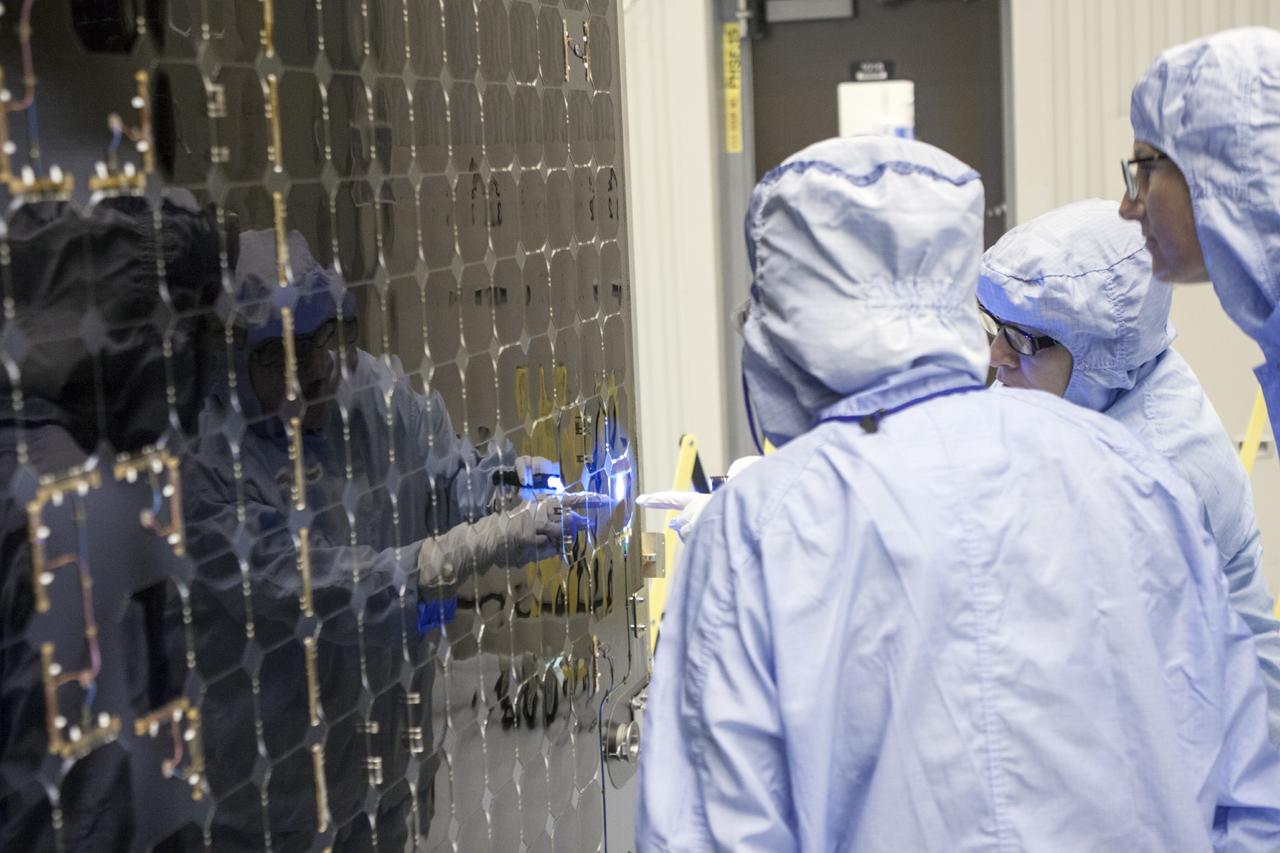 CAPE CANAVERAL, Fla. – Inside the Payload Hazardous Servicing Facility at NASA's Kennedy Space Center in Florida, technicians inspect one of the solar arrays for the Mars Atmosphere and Volatile Evolution, or MAVEN spacecraft. MAVEN is being prepared inside the facility for its scheduled November launch aboard a United Launch Alliance Atlas V rocket to Mars. Positioned in an orbit above the Red Planet, MAVEN will study the upper atmosphere of Mars in unprecedented detail. Photo credit: NASA/Jim Grossmann