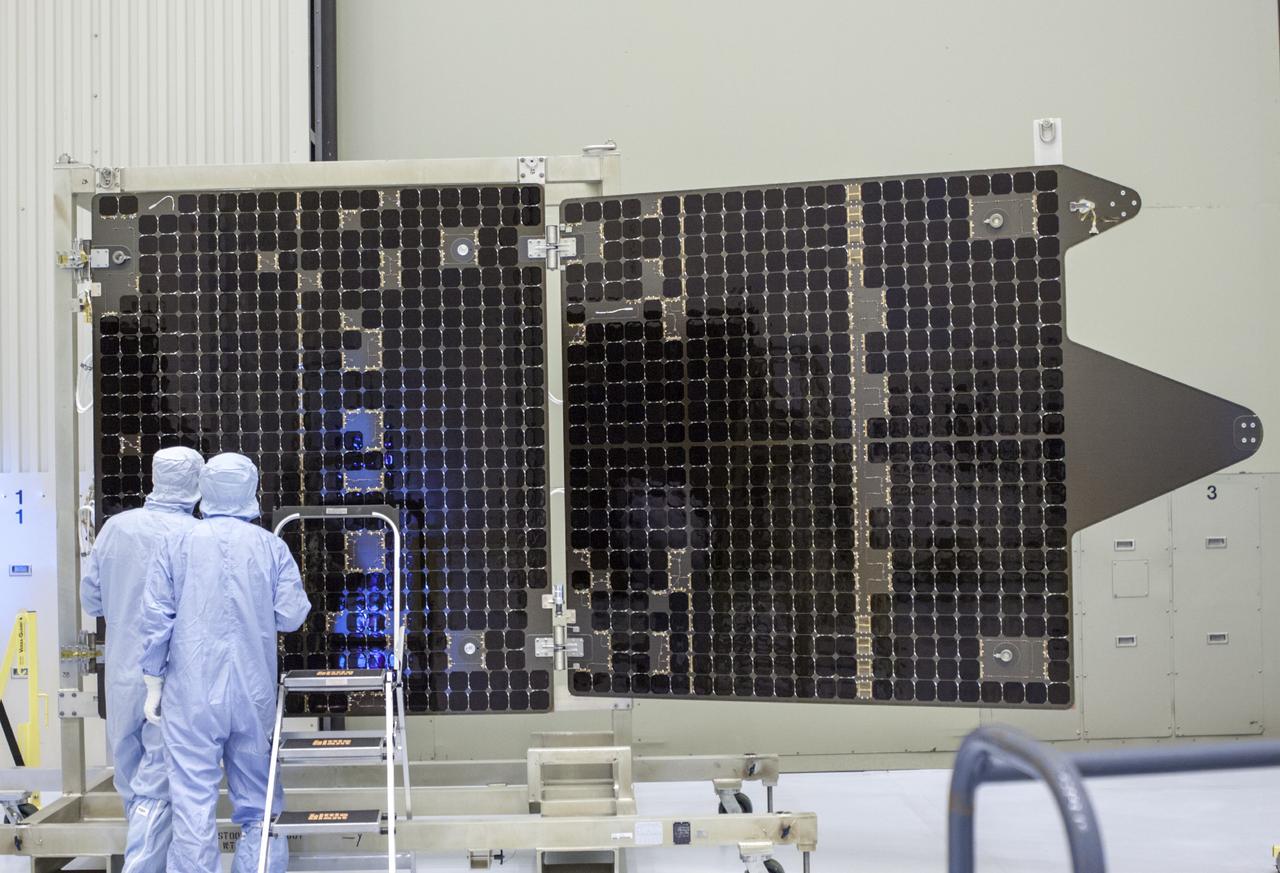 CAPE CANAVERAL, Fla. – Inside the Payload Hazardous Servicing Facility at NASA's Kennedy Space Center in Florida, technicians inspect one of the solar arrays for the Mars Atmosphere and Volatile Evolution, or MAVEN spacecraft. MAVEN is being prepared inside the facility for its scheduled November launch aboard a United Launch Alliance Atlas V rocket to Mars. Positioned in an orbit above the Red Planet, MAVEN will study the upper atmosphere of Mars in unprecedented detail. Photo credit: NASA/Jim Grossmann
