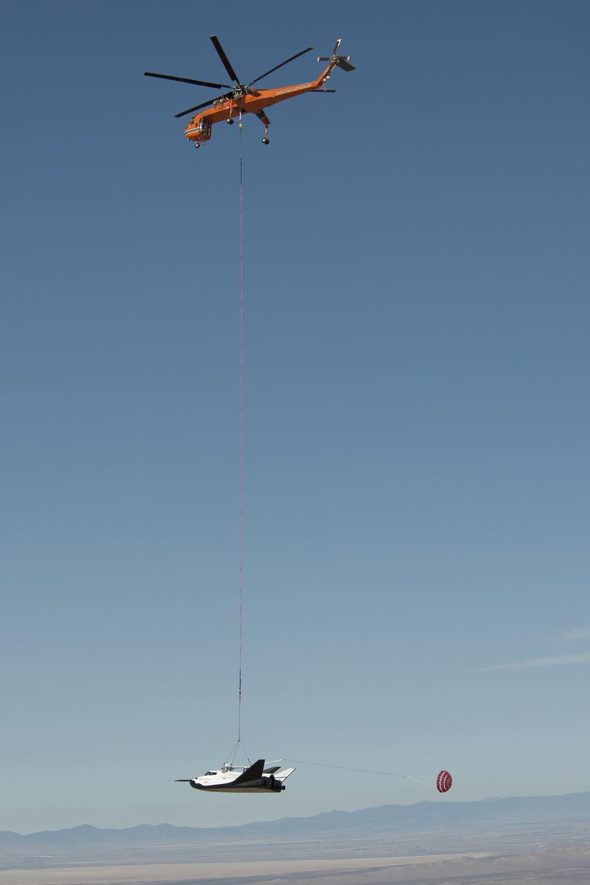 EDWARDS AFB, Calif. - ED13-0300-001 – An Erickson Air-Crane helicopter lifts Sierra Nevada Corporation's Dream Chaser flight vehicle during a captive-carry flight test. The test was a rehearsal for free flights at Edwards later this year. The spacecraft is under development in partnership with NASA's Commercial Crew Program. Although the spacecraft is designed for crew members, the vehicle will not have anyone onboard during the free flights. Photo credit: NASA/Carla Thomas