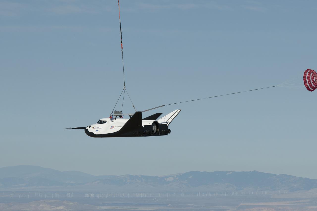 EDWARDS AFB, Calif. - ED13-0300-002 – An Erickson Air-Crane helicopter lifts Sierra Nevada Corporation's Dream Chaser flight vehicle during a captive-carry flight test. The test was a rehearsal for free flights at Edwards later this year. The spacecraft is under development in partnership with NASA's Commercial Crew Program. Although the spacecraft is designed for crew members, the vehicle will not have anyone onboard during the free flights. Photo credit: NASA/Carla Thomas