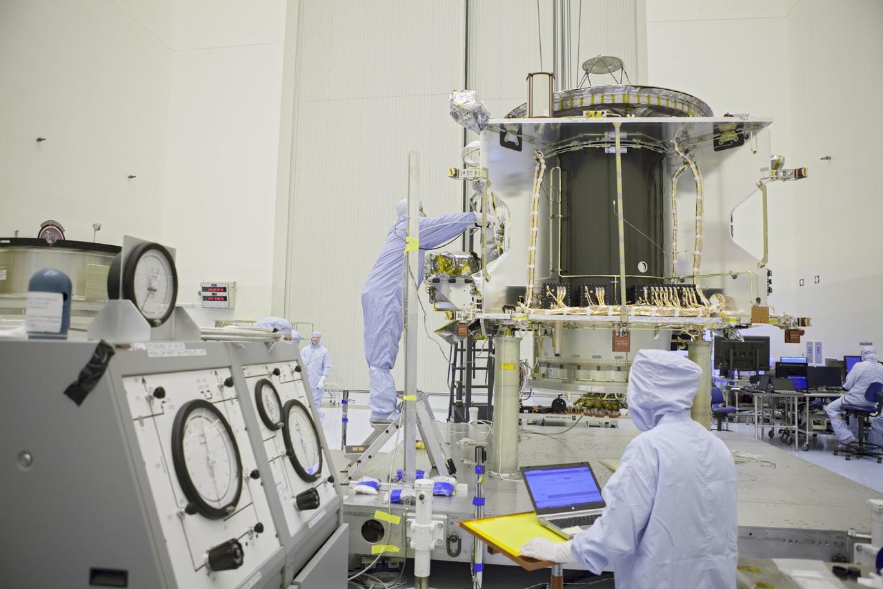CAPE CANAVERAL, Fla. – Inside the Payload Hazardous Servicing Facility at NASA's Kennedy Space Center in Florida, technicians prepare the rotation fixture to receive the Mars Atmosphere and Volatile Evolution spacecraft, or MAVEN, for further testing and prelaunch preparations next week. MAVEN is being readied for its scheduled November launch aboard a United Launch Alliance Atlas V rocket to Mars. Positioned in an orbit above the Red Planet, MAVEN will study the upper atmosphere of Mars in unprecedented detail. Photo credit: NASA/Chris Rhodes