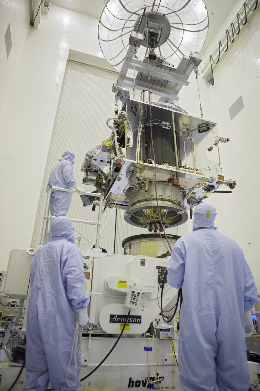 CAPE CANAVERAL, Fla. – Inside the Payload Hazardous Servicing Facility at NASA's Kennedy Space Center in Florida, technicians lower the Mars Atmosphere and Volatile Evolution spacecraft, or MAVEN, toward the rotation fixture for further testing and prelaunch preparations next week. MAVEN is being readied for its scheduled November launch aboard a United Launch Alliance Atlas V rocket to Mars. Positioned in an orbit above the Red Planet, MAVEN will study the upper atmosphere of Mars in unprecedented detail. Photo credit: NASA/Chris Rhodes