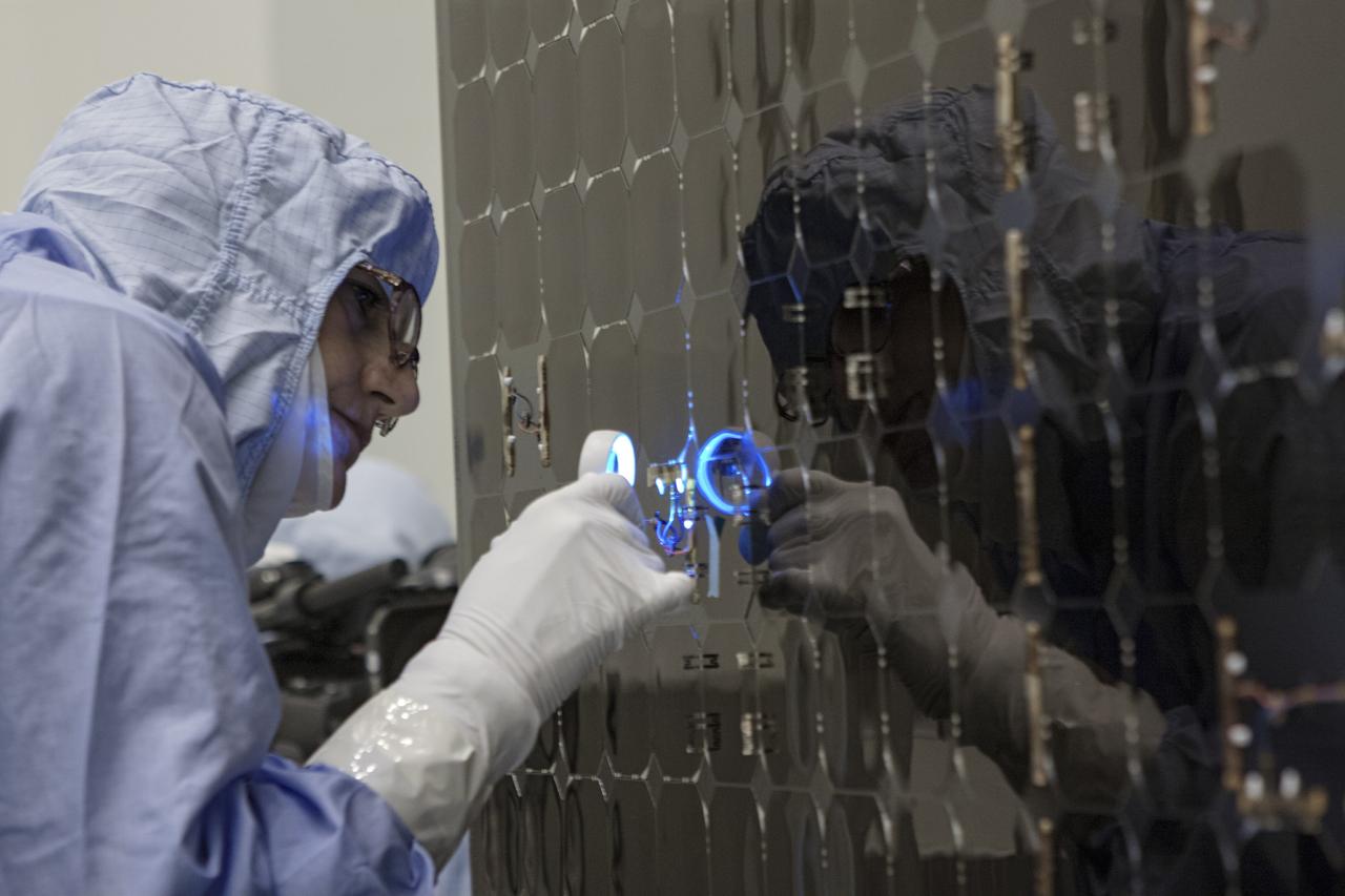 CAPE CANAVERAL, Fla. – Inside the Payload Hazardous Servicing Facility at NASA's Kennedy Space Center in Florida, a technician inspects a cell from one of the electricity-producing solar arrays for the Mars Atmosphere and Volatile Evolution, or MAVEN, spacecraft.      MAVEN is being prepared for its scheduled launch in November from Cape Canaveral Air Force Station, Fla. atop a United Launch Alliance Atlas V rocket. Positioned in an orbit above the Red Planet, MAVEN will study the upper atmosphere of Mars in unprecedented detail. For more information, visit: http://www.nasa.gov/mission_pages/maven/main/index.html Photo credit: NASA/ Jim Grossmann