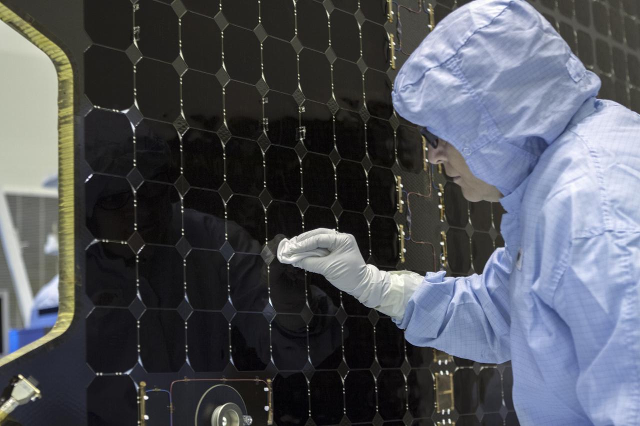 CAPE CANAVERAL, Fla. – Inside the Payload Hazardous Servicing Facility at NASA's Kennedy Space Center in Florida, a technician cleans one of the cells of the electricity-producing solar arrays for the Mars Atmosphere and Volatile Evolution, or MAVEN, spacecraft.       MAVEN is being prepared for its scheduled launch in November from Cape Canaveral Air Force Station, Fla. atop a United Launch Alliance Atlas V rocket. Positioned in an orbit above the Red Planet, MAVEN will study the upper atmosphere of Mars in unprecedented detail. For more information, visit: http://www.nasa.gov/mission_pages/maven/main/index.html Photo credit: NASA/ Jim Grossmann