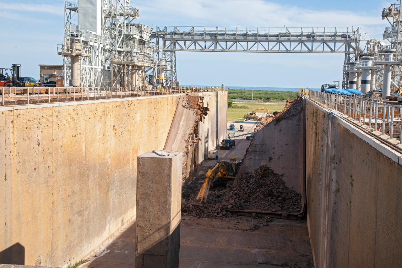 CAPE CANAVERAL, Fla. – A construction crew uses heavy machinery to take apart the flame deflector at Launch Complex 39B as the flame trench is refurbished for future rocket launches at NASA's Kennedy Space Center in Florida. Photo credit: NASA/Daniel Casper
