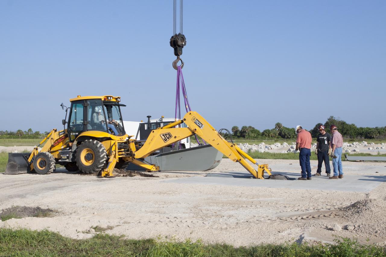 CAPE CANAVERAL, Fla. - Workers install a flame deflector at the Shuttle Landing Facility, or SLF, at NASA's Kennedy Space Center in Florida for the Project Morpheus lander. The site is adjacent to a hazard field created to support the project at the north end of the SLF. Testing of the prototype lander has been ongoing at NASA’s Johnson Space Center in Houston in preparation for a free flight at Kennedy later this year. The SLF will provide the lander with the kind of field necessary for realistic testing, complete with rocks, craters and hazards to avoid.         Morpheus utilizes an autonomous landing and hazard avoidance technology, or ALHAT, payload that will allow it to navigate to clear landing sites amidst obstacles during its descent. Project Morpheus is one of 20 small projects comprising the Advanced Exploration Systems, or AES, program in NASA’s Human Exploration and Operations Mission Directorate. AES projects pioneer new approaches for rapidly developing prototype systems, demonstrating key capabilities and validating operational concepts for future human missions beyond Earth orbit. For more information on Project Morpheus, visit http://www.nasa.gov/centers/johnson/exploration/morpheus/index.html. Photo credit: NASA/Kim Shiflett
