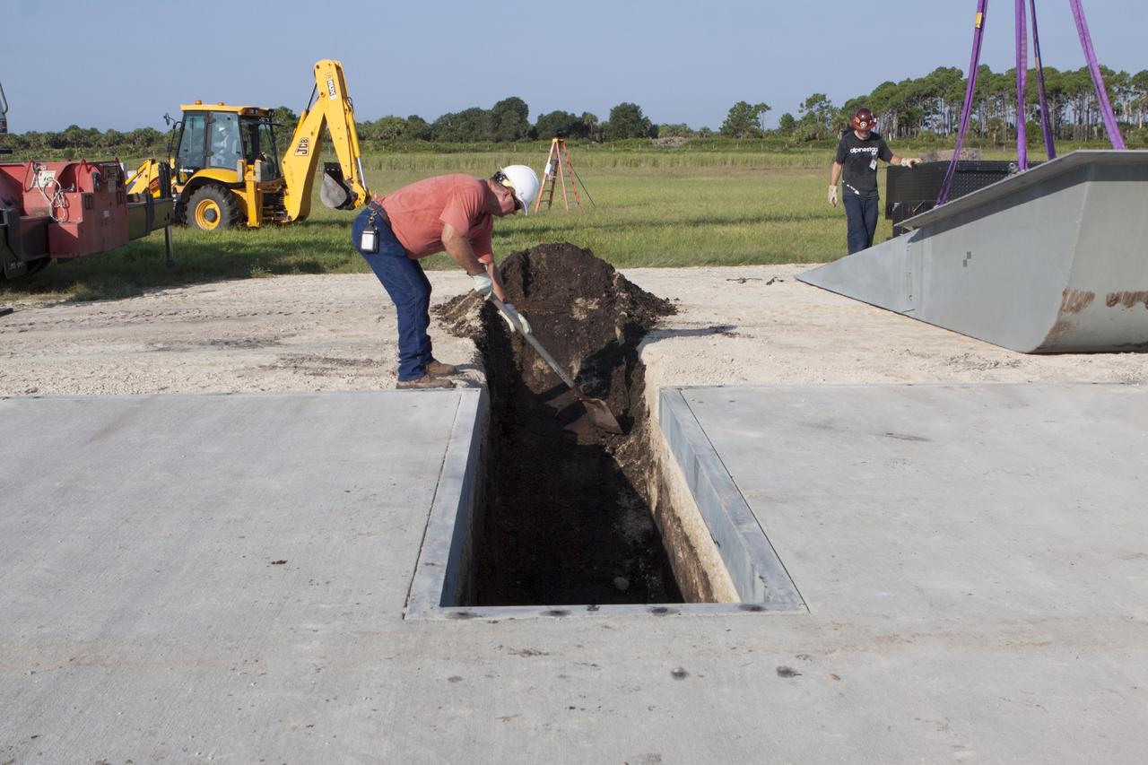 CAPE CANAVERAL, Fla. - Workers install a flame deflector at the Shuttle Landing Facility, or SLF, at NASA's Kennedy Space Center in Florida for the Project Morpheus lander. The site is adjacent to a hazard field created to support the project at the north end of the SLF. Testing of the prototype lander has been ongoing at NASA’s Johnson Space Center in Houston in preparation for a free flight at Kennedy later this year. The SLF will provide the lander with the kind of field necessary for realistic testing, complete with rocks, craters and hazards to avoid.         Morpheus utilizes an autonomous landing and hazard avoidance technology, or ALHAT, payload that will allow it to navigate to clear landing sites amidst obstacles during its descent. Project Morpheus is one of 20 small projects comprising the Advanced Exploration Systems, or AES, program in NASA’s Human Exploration and Operations Mission Directorate. AES projects pioneer new approaches for rapidly developing prototype systems, demonstrating key capabilities and validating operational concepts for future human missions beyond Earth orbit. For more information on Project Morpheus, visit http://www.nasa.gov/centers/johnson/exploration/morpheus/index.html. Photo credit: NASA/Kim Shiflett