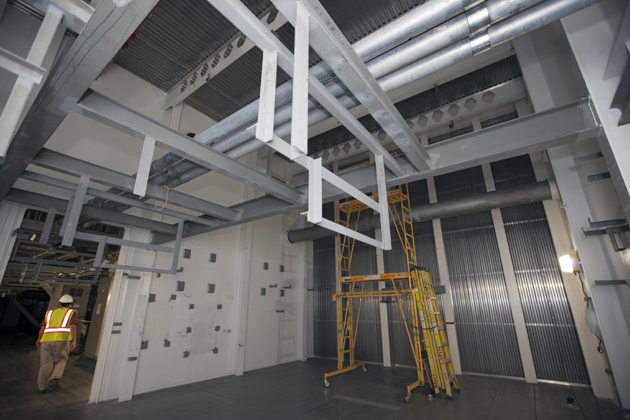 CAPE CANAVERAL, Fla. -- A worker inspects the interior of the mobile launcher, or ML, at the park site adjacent to the Vehicle Assembly Building, or VAB, at NASA's Kennedy Space Center in Florida.     Preparations are underway for modifications to begin to the outside of the 355-foot-tall ML structure this fall. NASA’s Ground Systems Development and Operations Program, or GSDO, is preparing the ML to support NASA’s Space Launch System, the heavy-lift rocket that will launch astronauts into deep space on future exploration missions. For more information, visit http://www.nasa.gov/exploration/systems/ground/index.html. Photo credit: NASA/Kim Shiflett