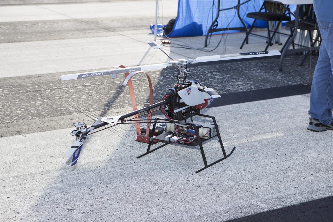CAPE CANAVERAL, Fla. – A remote-controlled helicopter with a unique set of sensors and software assembled by a team of engineers from NASA's Johnson Space Center prepares to fly in a competition at the agency's Kennedy Space Center. Teams from Johnson, Kennedy and Marshall Space Flight Center competed in an unmanned aerial systems event to evaluate designs and work by engineers learning new specialties. The competition took place at the Shuttle Landing Facility at Kennedy. Photo credit: NASA/Dmitri Gerondidakis