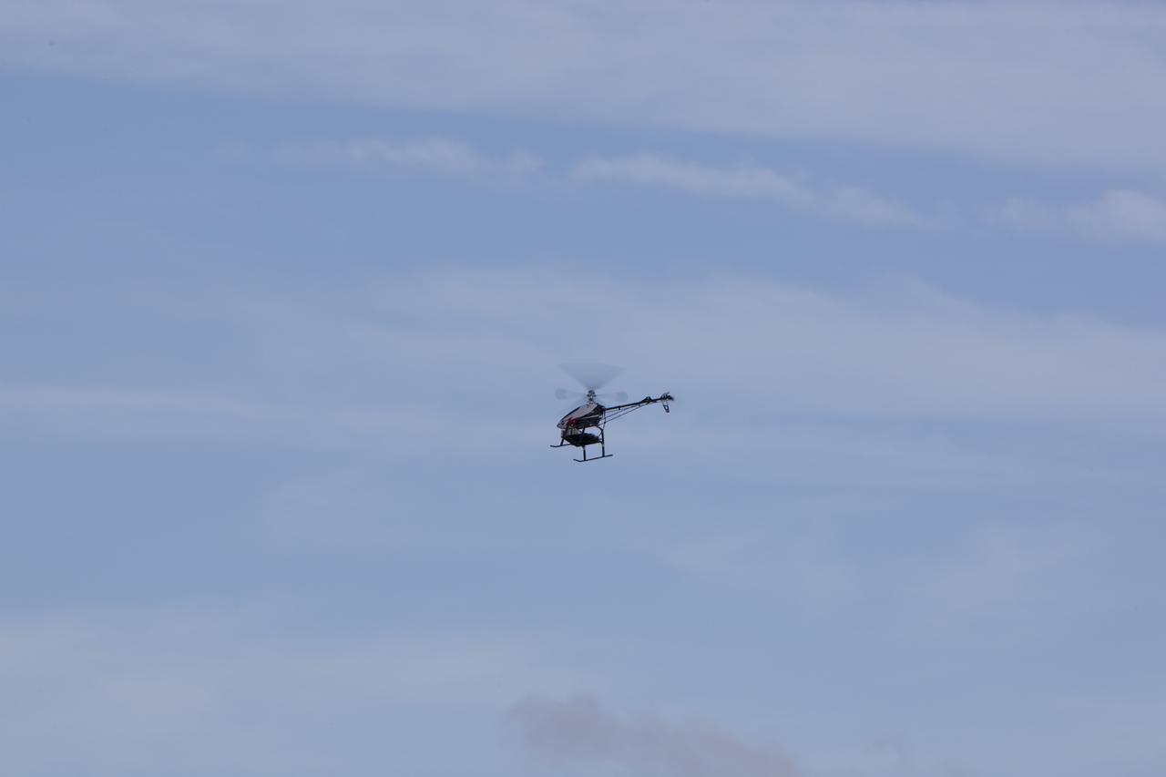 CAPE CANAVERAL, Fla. – A remote-controlled helicopter with a unique set of sensors and software assembled by a team of engineers from NASA's Johnson Space Center flies in a competition at the agency's Kennedy Space Center. Teams from Johnson, Kennedy and Marshall Space Flight Center competed in an unmanned aerial systems event to evaluate designs and work by engineers learning new specialties. The competition took place at the Shuttle Landing Facility at Kennedy. Photo credit: NASA/Dmitri Gerondidakis