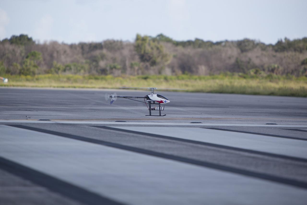 CAPE CANAVERAL, Fla. – A remote-controlled helicopter with a unique set of sensors and software assembled by a team of engineers from NASA's Johnson Space Center flies in a competition at the agency's Kennedy Space Center. Teams from Johnson, Kennedy and Marshall Space Flight Center competed in an unmanned aerial systems event to evaluate designs and work by engineers learning new specialties. The competition took place at the Shuttle Landing Facility at Kennedy. Photo credit: NASA/Dmitri Gerondidakis