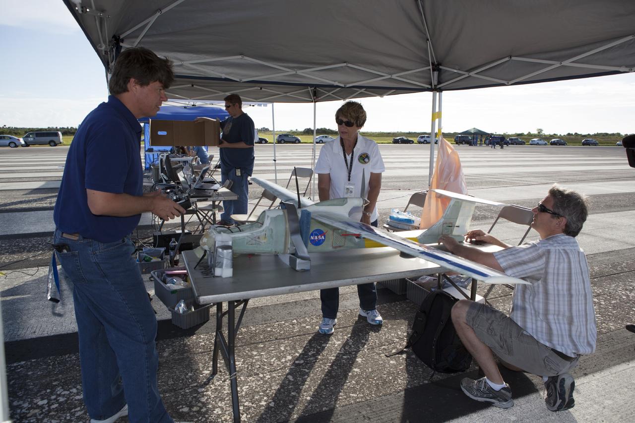 CAPE CANAVERAL, Fla. – Engineers from NASA's Kennedy Space Center prep a remote-controlled aircraft for take-off. The aircraft is equipped with a unique set of sensors and software and was assembled by a team of engineers for a competition at the agency's Kennedy Space Center. Teams from Johnson Space Center and Marshall Space Flight Center joined the Kennedy team in competing in an unmanned aerial systems event to evaluate designs and work by engineers learning new specialties. The competition took place at the Shuttle Landing Facility at Kennedy. Photo credit: NASA/Dmitri Gerondidakis