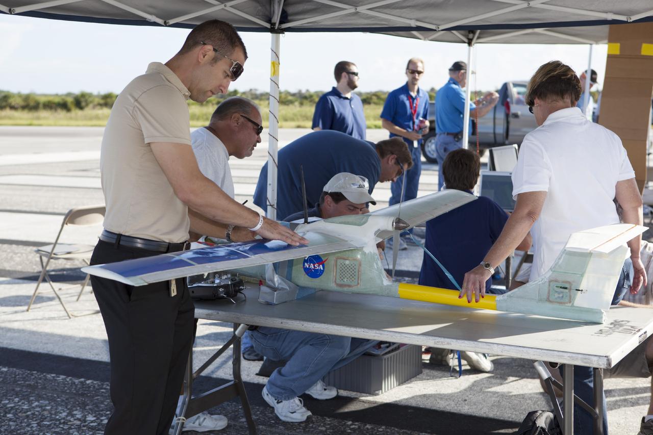 CAPE CANAVERAL, Fla. – Engineers from NASA's Kennedy Space Center prep a remote-controlled aircraft for take-off. The aircraft is equipped with a unique set of sensors and software and was assembled by a team of engineers for a competition at the agency's Kennedy Space Center. Teams from Johnson Space Center and Marshall Space Flight Center joined the Kennedy team in competing in an unmanned aerial systems event to evaluate designs and work by engineers learning new specialties. The competition took place at the Shuttle Landing Facility at Kennedy. Photo credit: NASA/Dmitri Gerondidakis