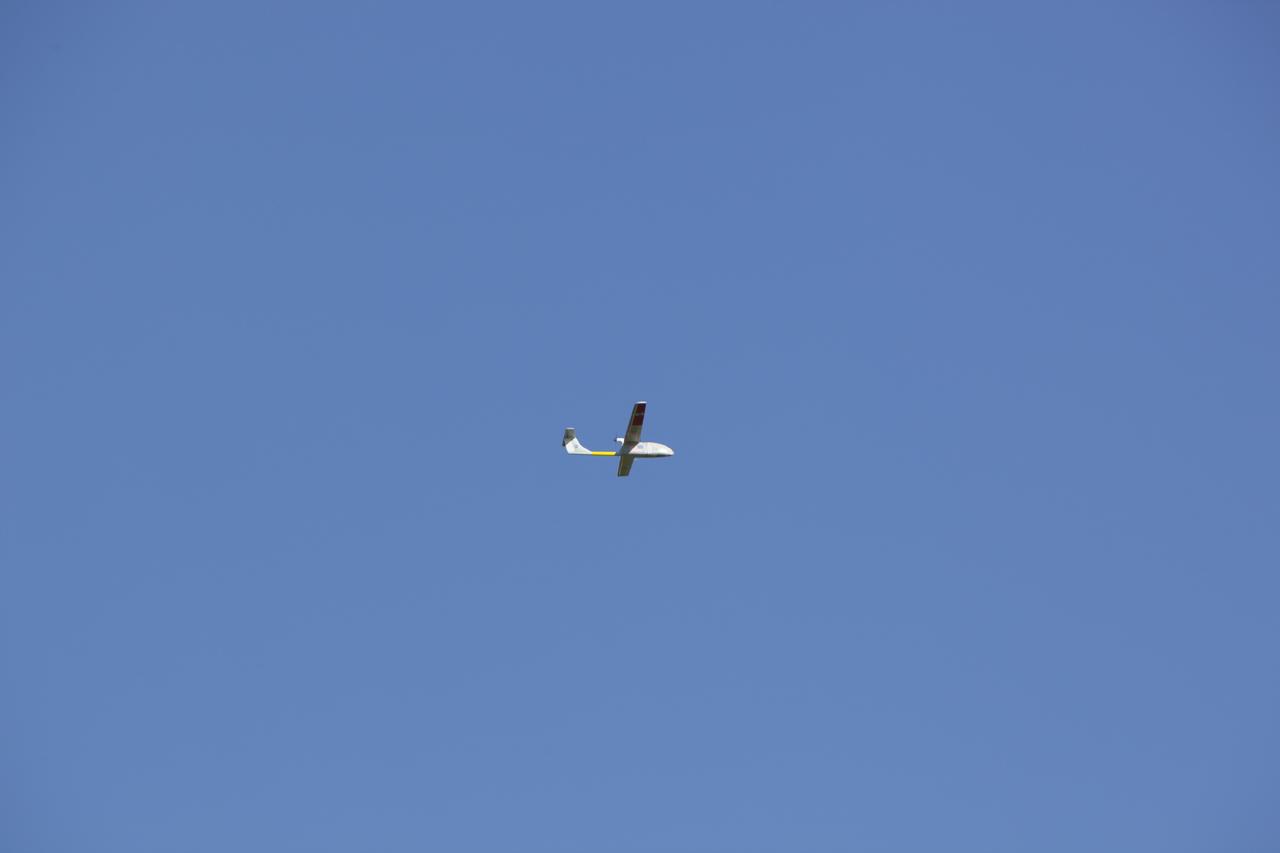 CAPE CANAVERAL, Fla. – A remote-controlled aircraft flies during a competition with a unique set of sensors and software to conduct a mock search-and-rescue operation. The aircraft was assembled by a team of engineers from NASA's Kennedy Space Center. Teams from Johnson Space Center, Kennedy and Marshall Space Flight Center competed in the unmanned aerial systems event to evaluate designs and work by engineers learning new specialties. The competition took place at the Shuttle Landing Facility at Kennedy. Photo credit: NASA/Dmitri Gerondidakis