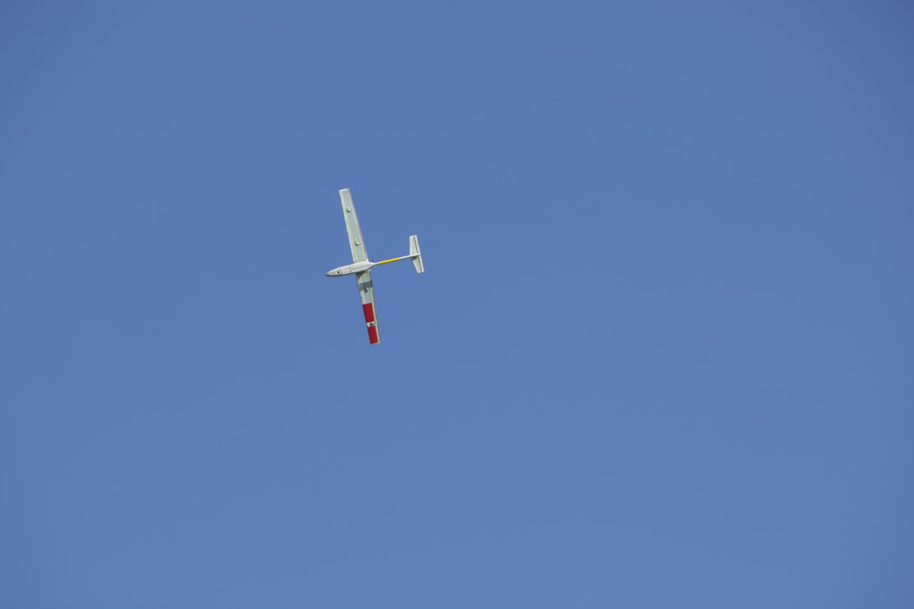 CAPE CANAVERAL, Fla. – A remote-controlled aircraft flies during a competition with a unique set of sensors and software to conduct a mock search-and-rescue operation. The aircraft was assembled by a team of engineers from NASA's Kennedy Space Center. Teams from Johnson Space Center, Kennedy and Marshall Space Flight Center competed in the unmanned aerial systems event to evaluate designs and work by engineers learning new specialties. The competition took place at the Shuttle Landing Facility at Kennedy. Photo credit: NASA/Dmitri Gerondidakis