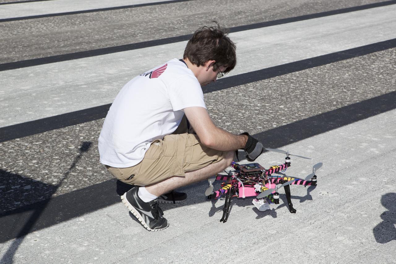 CAPE CANAVERAL, Fla. – An engineer from NASA's Marshall Space Flight Center prep a remote-controlled aircraft for take-off. The aircraft is equipped with a unique set of sensors and software and was assembled by a team of engineers for a competition at the agency's Kennedy Space Center. Teams from Johnson Space Center and Marshall Space Flight Center joined the Kennedy team in competing in an unmanned aerial systems event to evaluate designs and work by engineers learning new specialties. The competition took place at the Shuttle Landing Facility at Kennedy. Photo credit: NASA/Dmitri Gerondidakis