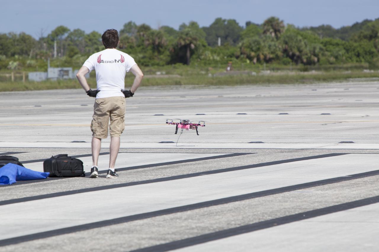 CAPE CANAVERAL, Fla. – An engineer from NASA's Marshall Space Flight Center watches the landing of remote-controlled aircraft. The aircraft is equipped with a unique set of sensors and software and was assembled by a team of engineers for a competition at the agency's Kennedy Space Center. Teams from Johnson Space Center and Marshall Space Flight Center joined a Kennedy team in competing in an unmanned aerial systems event to evaluate designs and work by engineers learning new specialties. The competition took place at the Shuttle Landing Facility at Kennedy. Photo credit: NASA/Dmitri Gerondidakis
