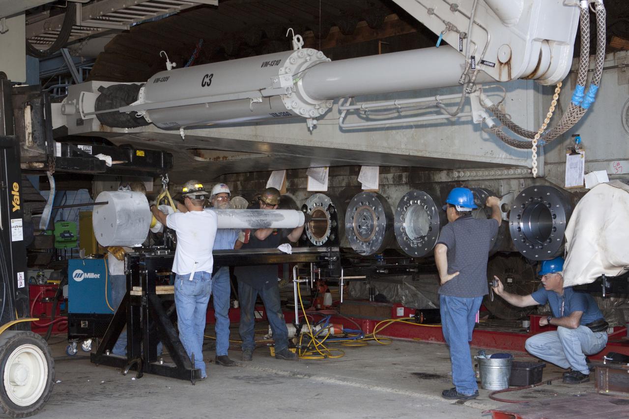 CAPE CANAVERAL, Fla. -- Technicians install a new bearing on crawler-transporter 2 in Vehicle Assembly Building High Bay 2 at NASA's Kennedy Space Center in Florida.      Modifications underway on the crawler are designed to ensure its ability to transport launch vehicles currently under development, such as the agency’s Space Launch System, to the launch pad. Present modifications represent a redesign and upgrade to the roller bearings and assemblies originally installed on the crawler. The Ground Systems Development and Operations Program office at Kennedy is overseeing the upgrades. For more than 45 years the crawler-transporters were used to transport the mobile launcher platform carrying the Apollo-Saturn V rockets and space shuttles to Launch Pads 39A and 39B. For more information, visit http://www.nasa.gov/exploration/systems/ground/crawler-transporter_bearings_prt.htm. Photo credit: NASA/Kim Shiflett