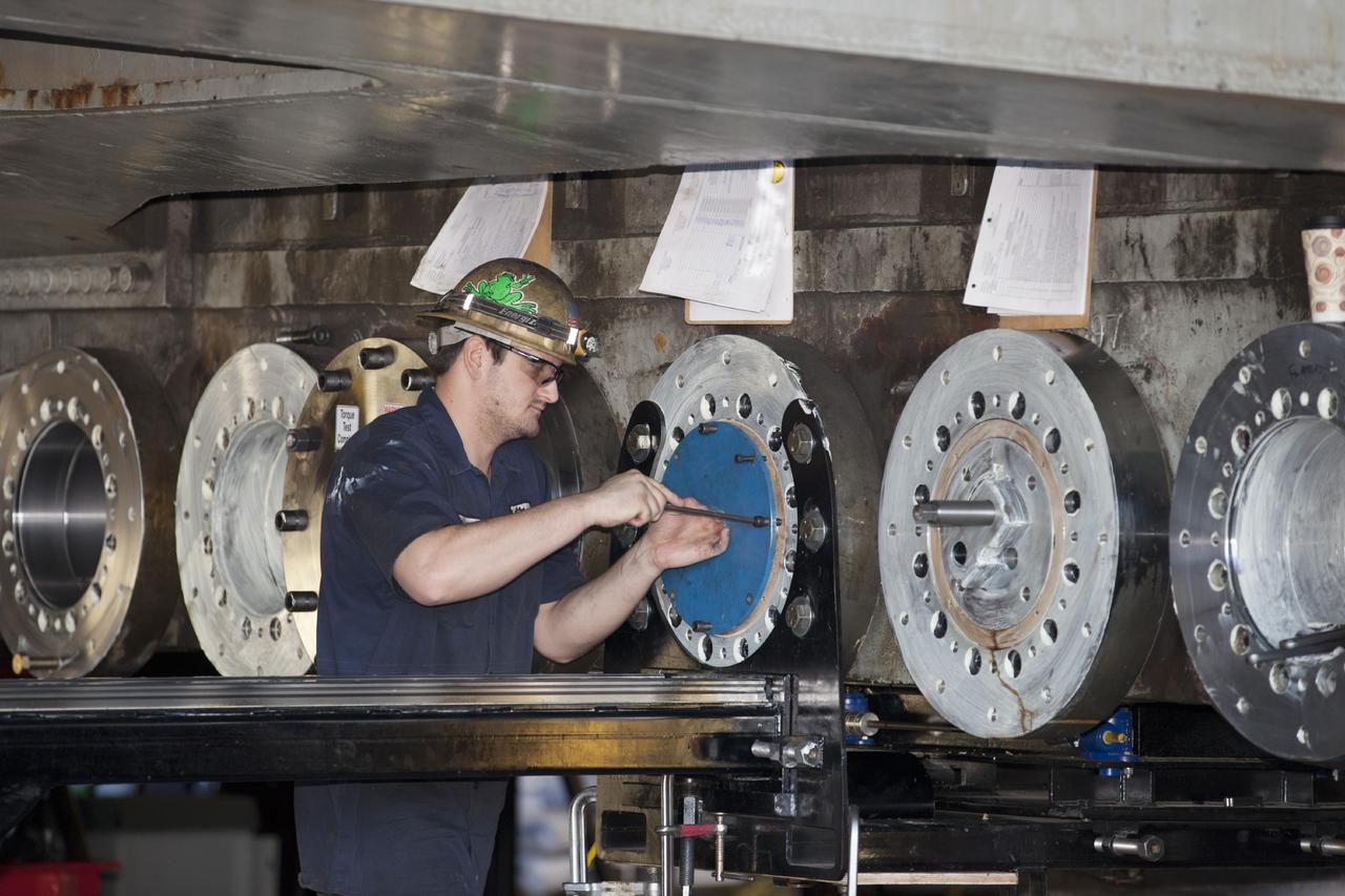 CAPE CANAVERAL, Fla. -- A technician installs a new bearing on crawler-transporter 2 in Vehicle Assembly Building High Bay 2 at NASA's Kennedy Space Center in Florida.      Modifications underway on the crawler are designed to ensure its ability to transport launch vehicles currently under development, such as the agency’s Space Launch System, to the launch pad. Present modifications represent a redesign and upgrade to the roller bearings and assemblies originally installed on the crawler. The Ground Systems Development and Operations Program office at Kennedy is overseeing the upgrades. For more than 45 years the crawler-transporters were used to transport the mobile launcher platform carrying the Apollo-Saturn V rockets and space shuttles to Launch Pads 39A and 39B. For more information, visit http://www.nasa.gov/exploration/systems/ground/crawler-transporter_bearings_prt.htm. Photo credit: NASA/Kim Shiflett