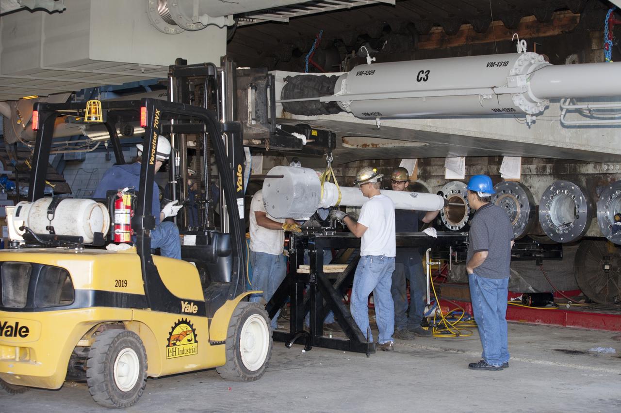 CAPE CANAVERAL, Fla. -- Technicians install a new bearing on crawler-transporter 2 in Vehicle Assembly Building High Bay 2 at NASA's Kennedy Space Center in Florida.      Modifications underway on the crawler are designed to ensure its ability to transport launch vehicles currently under development, such as the agency’s Space Launch System, to the launch pad. Present modifications represent a redesign and upgrade to the roller bearings and assemblies originally installed on the crawler. The Ground Systems Development and Operations Program office at Kennedy is overseeing the upgrades. For more than 45 years the crawler-transporters were used to transport the mobile launcher platform carrying the Apollo-Saturn V rockets and space shuttles to Launch Pads 39A and 39B. For more information, visit http://www.nasa.gov/exploration/systems/ground/crawler-transporter_bearings_prt.htm. Photo credit: NASA/Kim Shiflett
