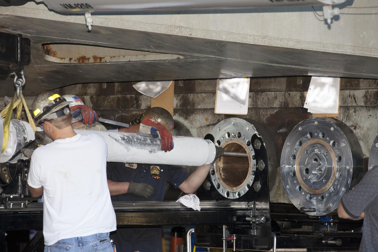 CAPE CANAVERAL, Fla. -- A technician installs a new bearing on crawler-transporter 2 in Vehicle Assembly Building High Bay 2 at NASA's Kennedy Space Center in Florida.      Modifications underway on the crawler are designed to ensure its ability to transport launch vehicles currently under development, such as the agency’s Space Launch System, to the launch pad. Present modifications represent a redesign and upgrade to the roller bearings and assemblies originally installed on the crawler. The Ground Systems Development and Operations Program office at Kennedy is overseeing the upgrades. For more than 45 years the crawler-transporters were used to transport the mobile launcher platform carrying the Apollo-Saturn V rockets and space shuttles to Launch Pads 39A and 39B. For more information, visit http://www.nasa.gov/exploration/systems/ground/crawler-transporter_bearings_prt.htm. Photo credit: NASA/Kim Shiflett
